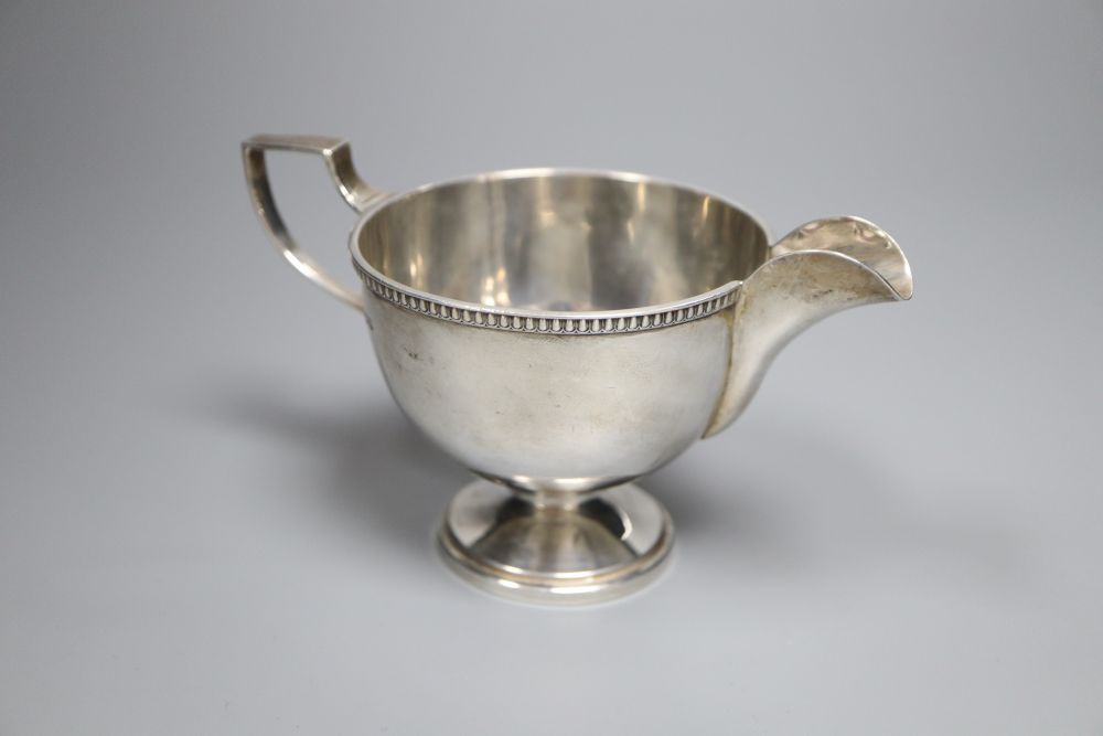 A George V silver pedestal cream jug, Walker & Hall, Sheffield, 1930, 85mm,